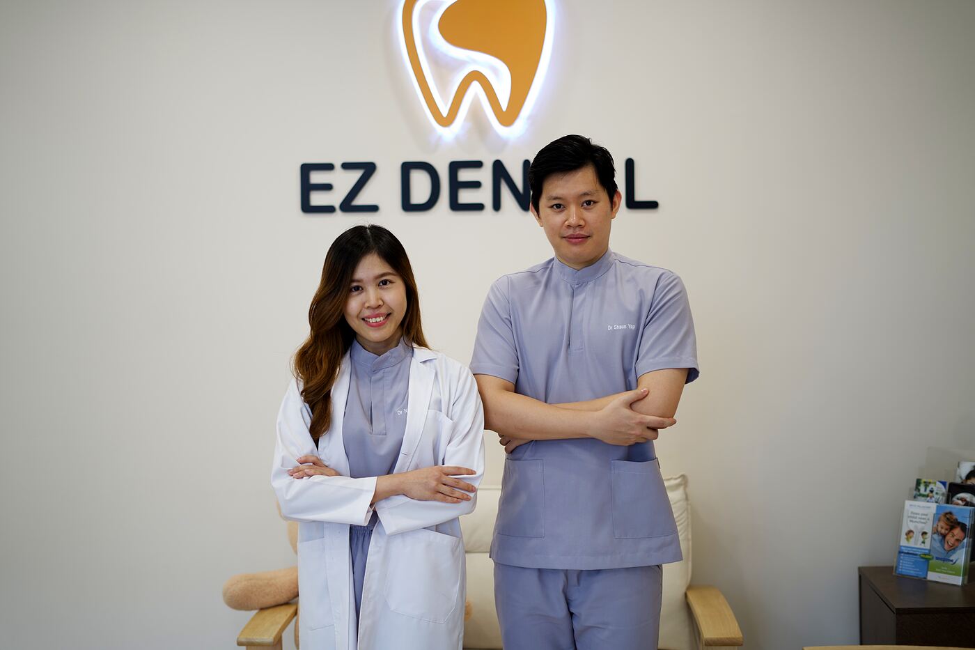 Dr. Shaun Yap and Dr. Nicole standing together under the Ez Dental sign